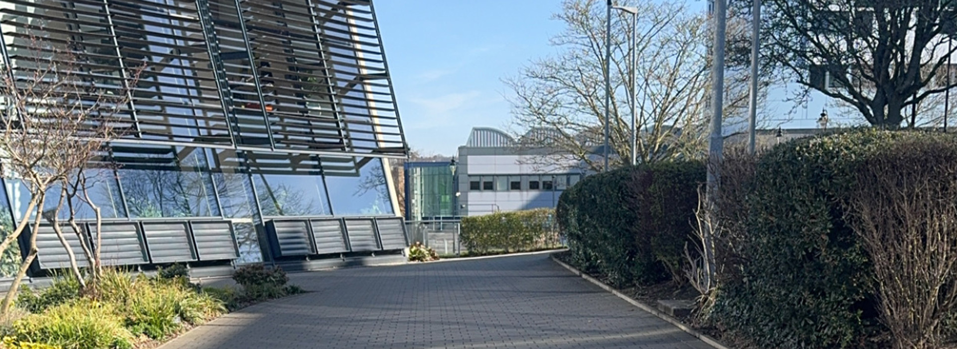 Immar walking past the School of Management building.