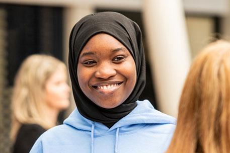 A student ambassador chatting to an attendee at an event.