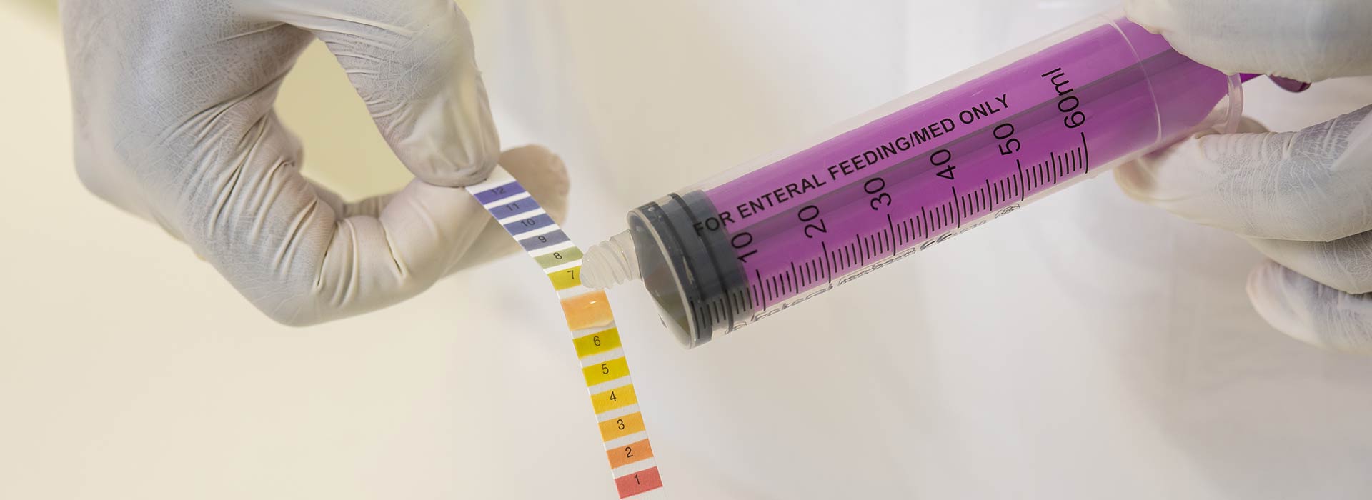 A student testing the PH of a sample.