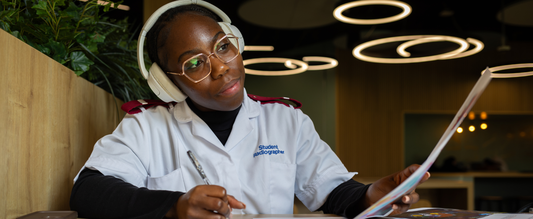 A student in a white shirt with the words 
