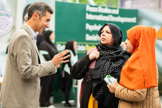 An applicant and their parent chatting to an academic at an Open Day.