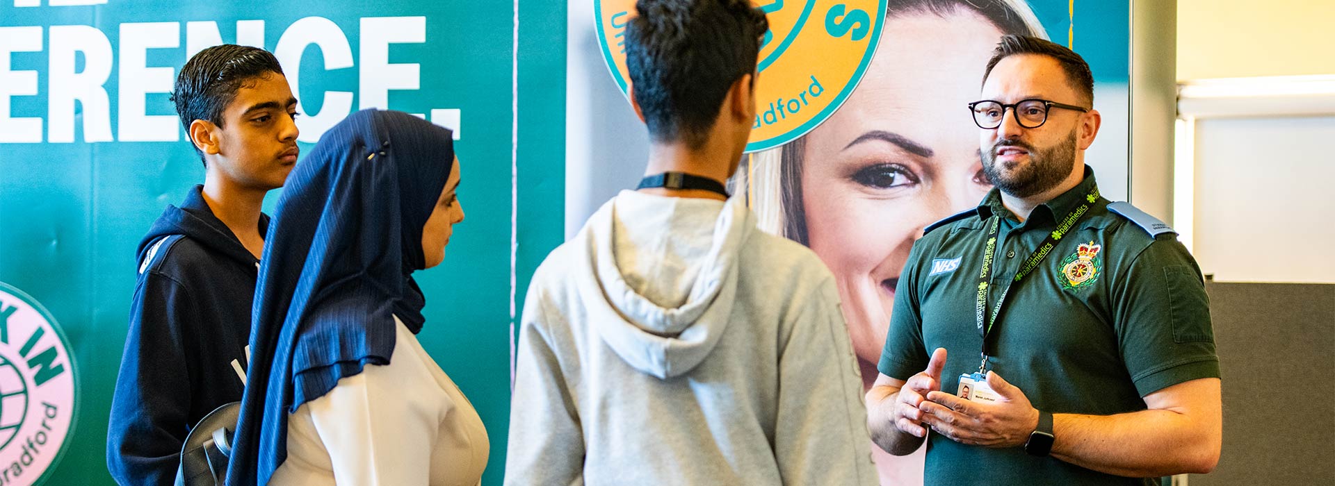 A prospective student chatting to a paramedic science student at an Open Day.