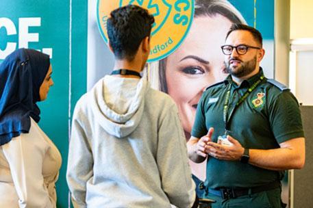 A paramedic science lecturer speaking to attendees at an Open Day.